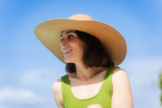 Beautiful woman wearing sunhat outdoors