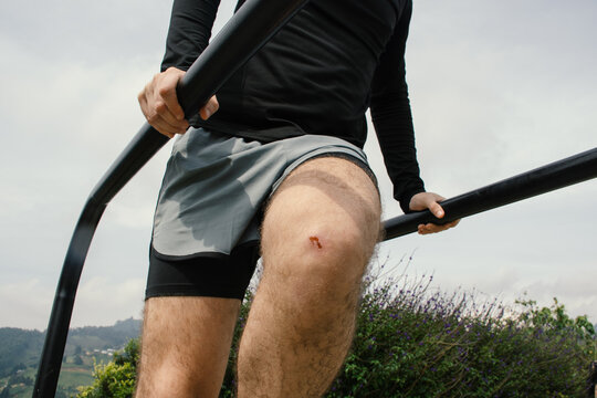 Outdoor fitness practice involves pull-up exercise near park