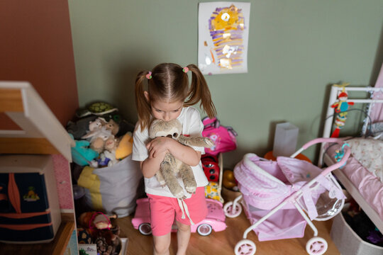 Child Hugging a Soft Toy in Her Room
