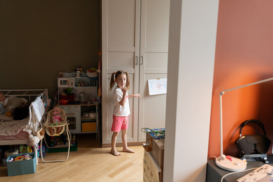 Girl Standing in Her Playroom