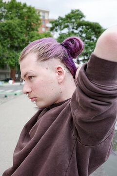 Young Man With Purple Hair in an Urban Park