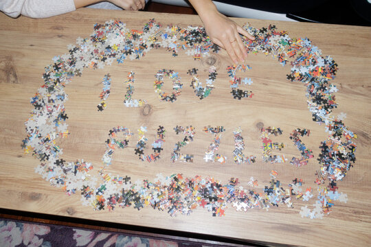 A young woman is putting together a puzzle
