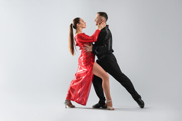 Couple of professional dancers on grey background