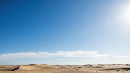 Obraz premium Desert landscape under bright sunlight with clear blue sky