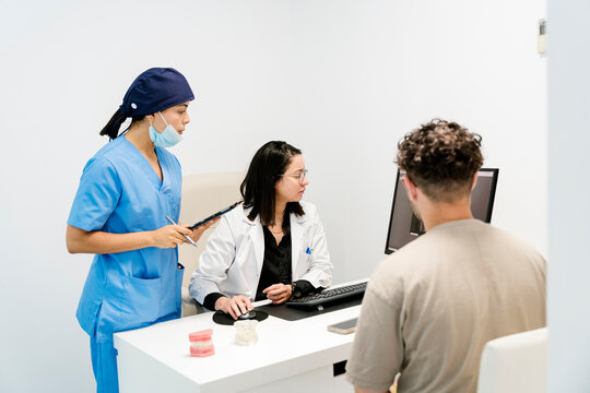Dentist showing x-ray to patient in dental clinic
