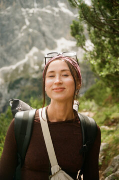 Woman standing against snowy mountain backdrop

