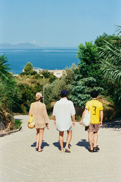 Three friends walking to a mediterranean beach in Albania, summer trip