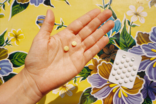 Hand Holding Medicine Pills. Film