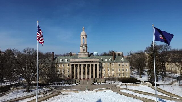 Aerial view of the Old Main building in the campus of Penn State University, drone video in winter sunny day, State College, Pennsylvania.