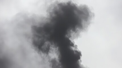 Fototapeta premium Thick dark smoke plumes rising into an overcast sky, symbolizing industrial pollution and its environmental impact.
