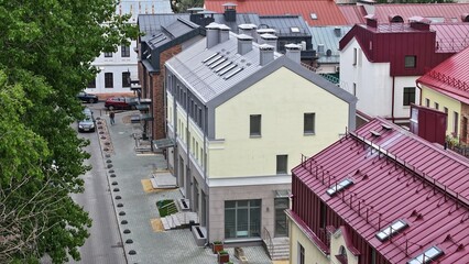 Typical Europe. A low-rise street in a European city. Three-story houses with dormer windows, narrow streets in a European city.