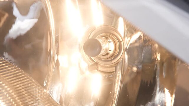 Car headlight turning on and off in close up, bright halogen illumination, modern automotive lighting detail, night driving safety, vehicle technology, visibility control