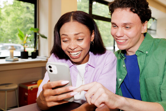 Man and Woman Laughing at Phone 