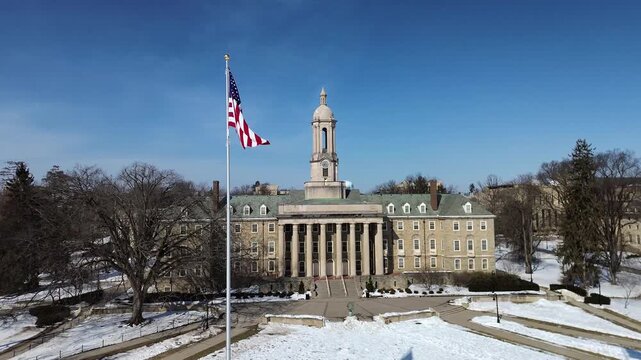 Aerial view of the Old Main building in the campus of Penn State University, drone video in winter sunny day, State College, Pennsylvania.