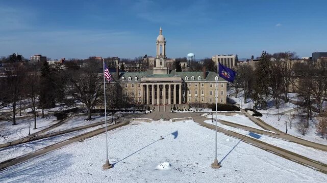 Aerial view of the Old Main building in the campus of Penn State University, drone video in winter sunny day, State College, Pennsylvania.