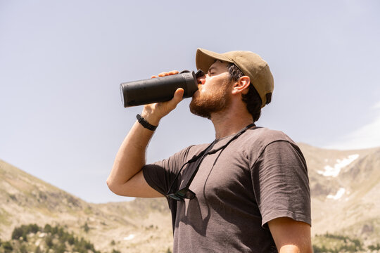 Man drinking water reusable bottle