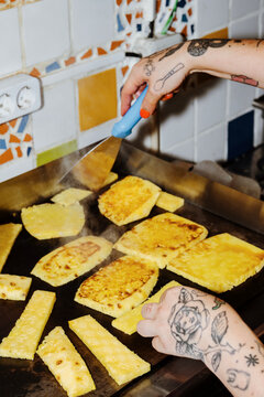 Grilling Fresh Pineapple Slices in a Vibrant Kitchen Setting