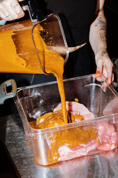 Cooking Process in a Kitchen With Marinated Meat Preparation