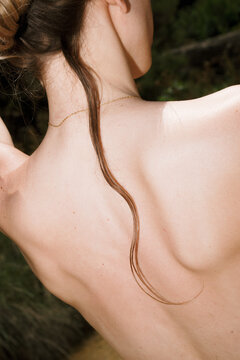 Long hair flowing down the back in a natural setting
