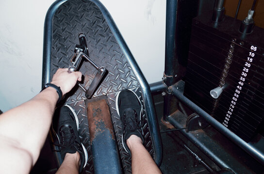 Strength Training Activity Featuring Leg Press Machine in Gym