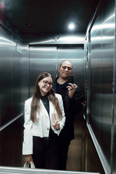 Couple Enjoying a Playful Moment in an Elevator