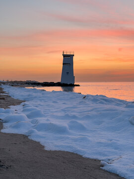 Breezy Point lighthouse in winter sunset, Queens, New York with Manhattan Beach, Brighton Beach, and Coney Island in Brooklyn in horizon across the water