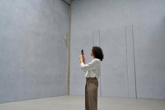 Woman taking photos in an empty room