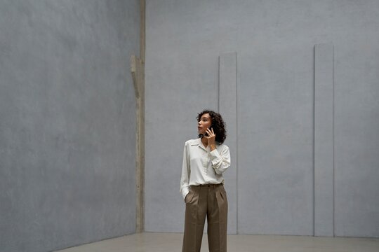 Woman on the Phone Explores Spacious Loft With Minimalist Design