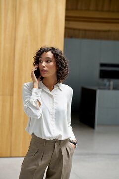 Business Professional Speaking on Phone in Modern Office Setting