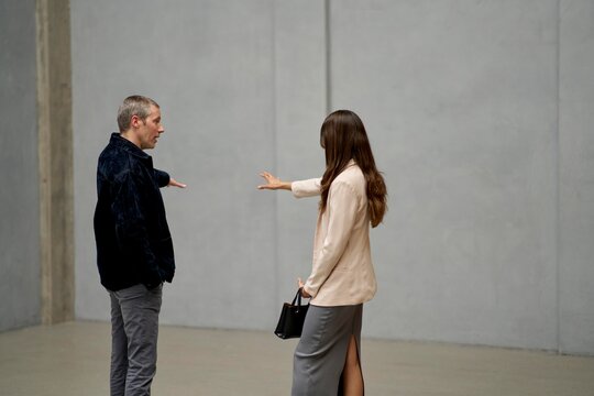 Couple Discussing Details in Modern Property During Daytime
