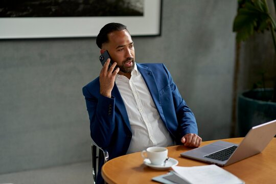Businessman Having a Phone Conversation While Working in an Office