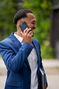 Businessman Conversing on Phone Outside a Modern Building