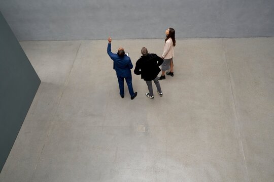 Three people exploring modern apartment in urban setting