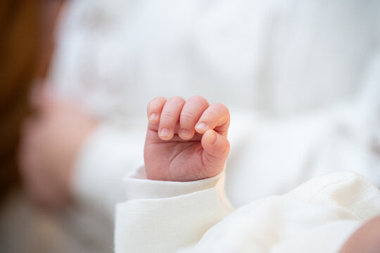 Holy infant baptism ceremony in Christian church, priest holding baby during christening ritual with candles and parents nearby, spiritual sacrament, sacred family celebration