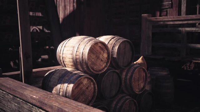 A collection of wooden barrels is stacked neatly in a weathered warehouse, illuminated by soft afternoon sunlight that highlights their textures and craftsmanship.