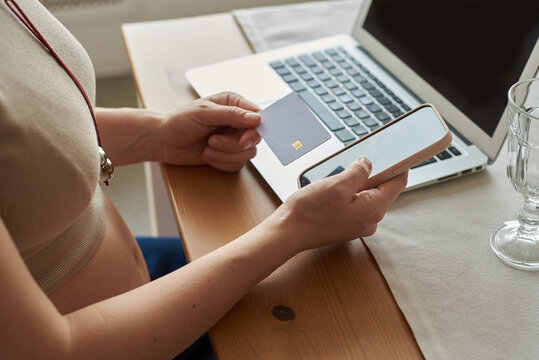 Pregnant woman making online payment using smartphone 