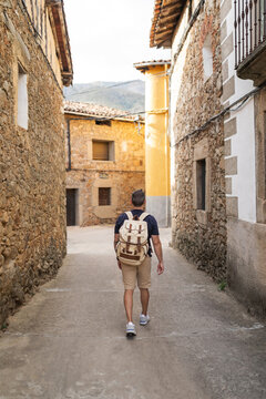 Man walking through village street