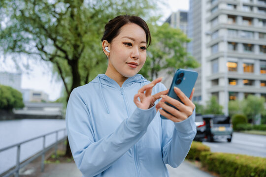A woman uses a mobile phone while exercising