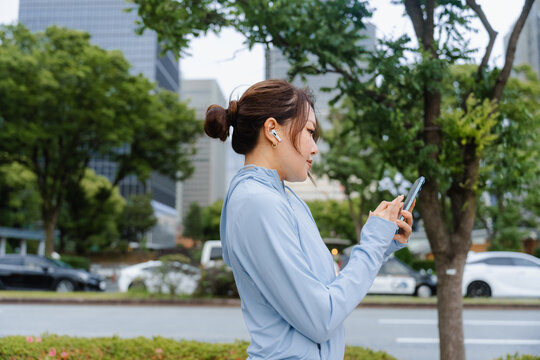 A woman uses a mobile phone while exercising