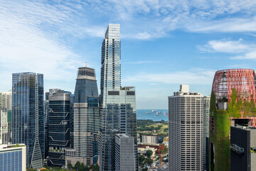 Modern glass skyscrapers of the Marina Bay financial district with sea and anchored ships visible in the background, Singapore © vadim.nefedov