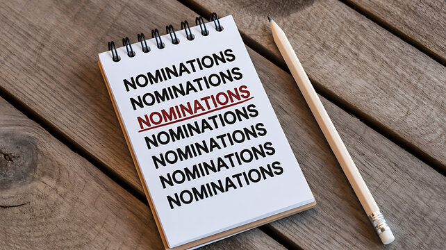 Spiral Notebook with Nominations on Wooden Desk with Pencil