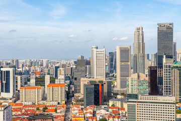 Panoramic skyline of Singapore central business district with dense modern skyscrapers and traditional red residential rooftops © vadim.nefedov