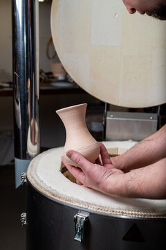 Potter takes the finished clay pots out of the kiln