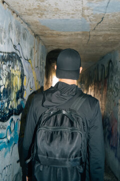 Man Walking Through Tunnel