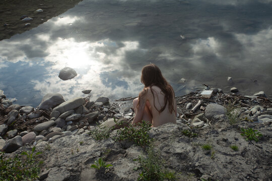 A naked woman  at the river 