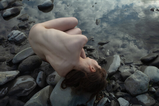 A naked woman  at the river 