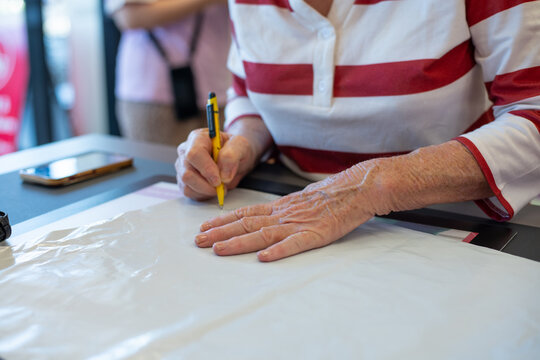 senior woman writing on an envelope