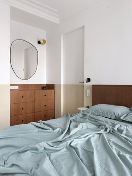 Bedroom in a Soft Color Palette with rounded mirror