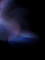 A blurry image of a purple and blue light with a dark background. The light is in the center of the...