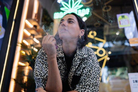 Woman smoking outside a dispensary